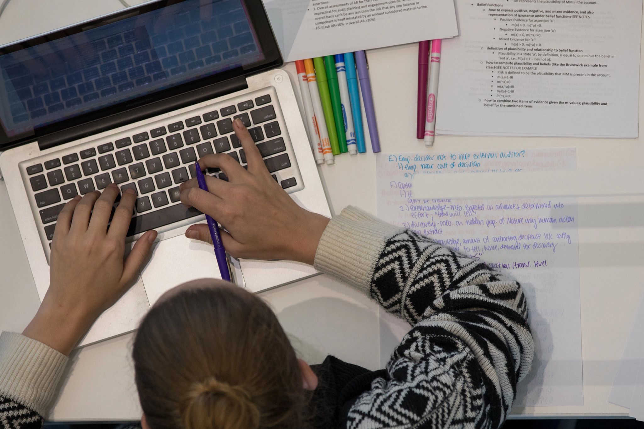 Looking down at a student working at a computer