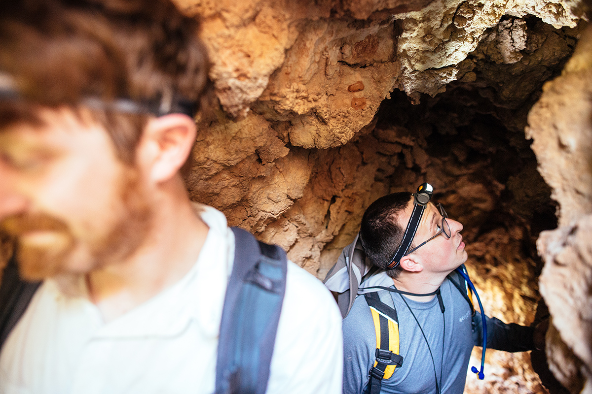 Two students, walking through a cave. <a href=