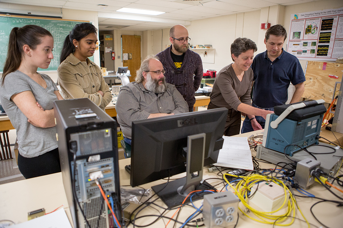 Professor Alice Bean works with KU students in her particle physics lab.